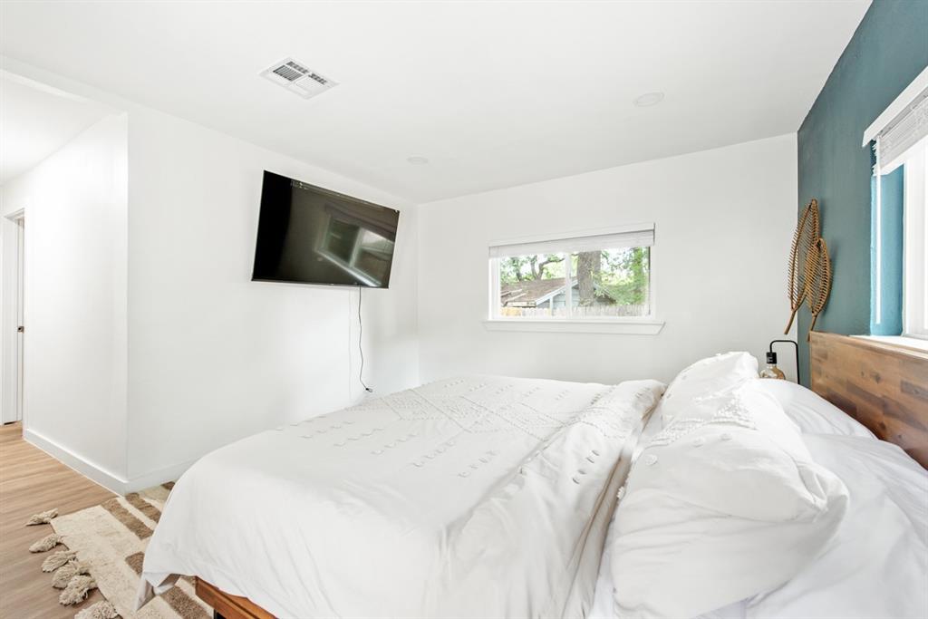 4252 McComas Road Haltom City, TX 76117 - Photo 20 of 35 a bedroom with a large bed and a flat screen tv