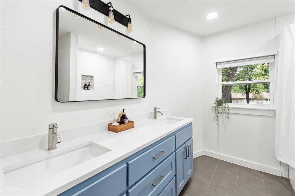 4252 McComas Road Haltom City, TX 76117 - Photo 27 of 35 a bathroom with a sink and a mirror