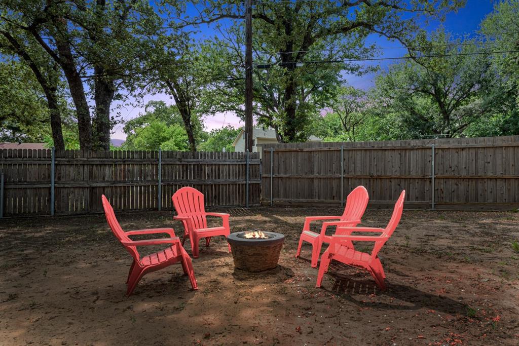 4252 McComas Road Haltom City, TX 76117 - Photo 3 of 35 a view of a backyard with two chairs and a fire pit