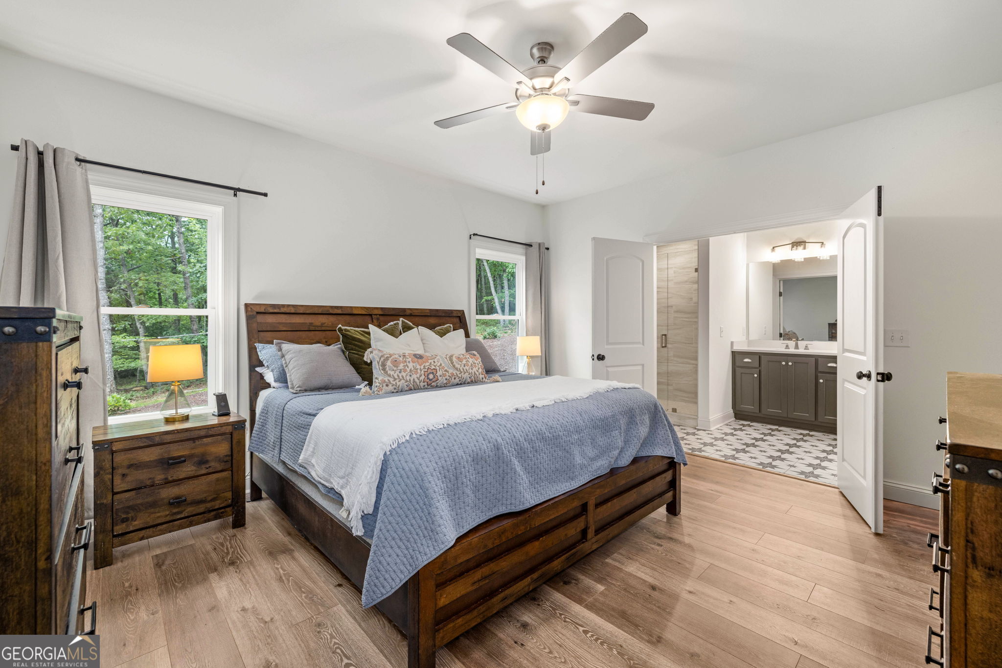 373 McIntosh Road Clarkesville, GA 30523 - Photo 14 of 92 a spacious bedroom with a bed and a chandelier