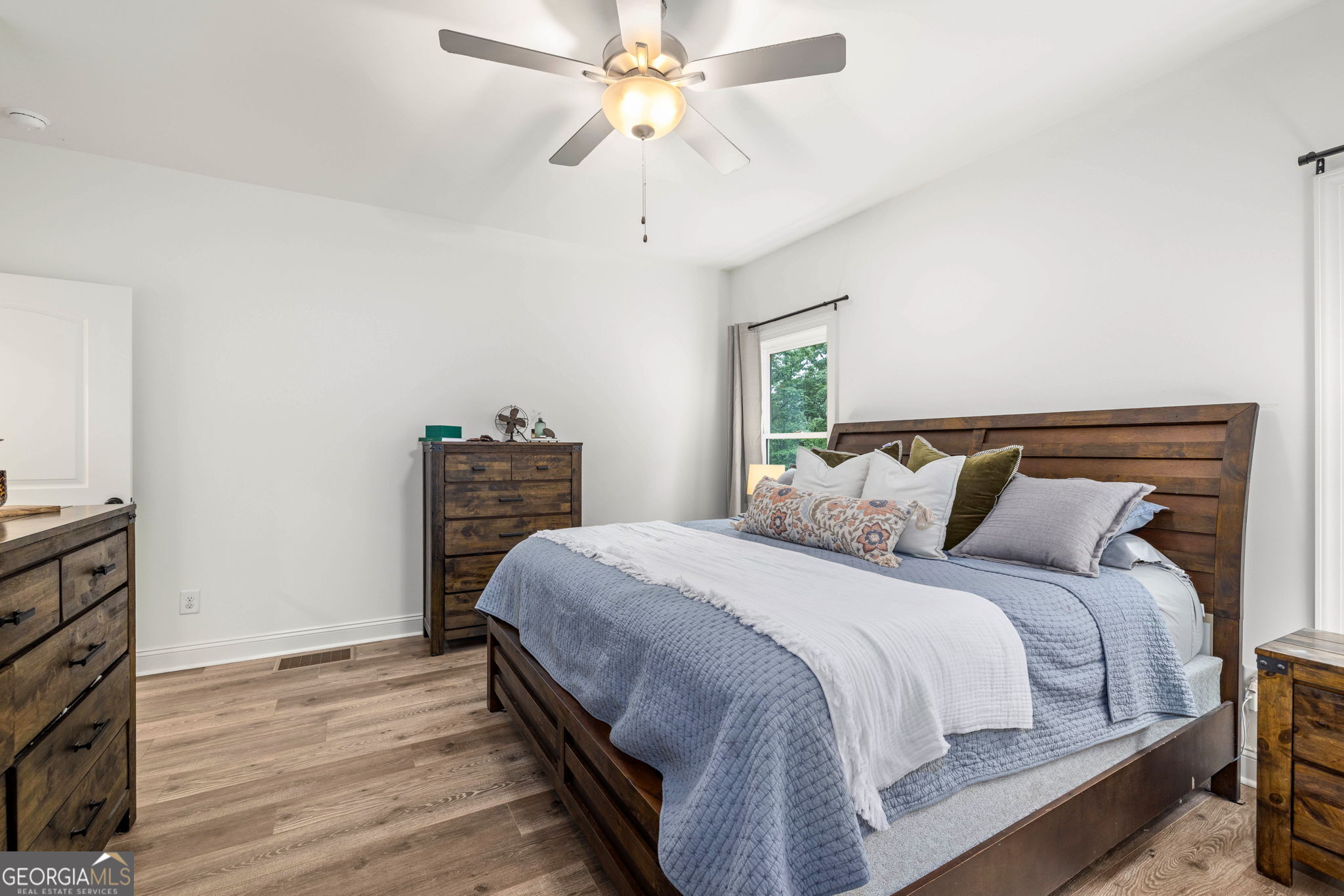 373 McIntosh Road Clarkesville, GA 30523 - Photo 15 of 92 a bedroom with bed and a chandelier