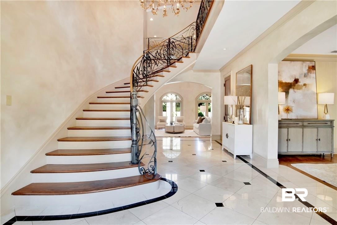 4 Chancery Court Mobile, AL 36608 - Photo 3 of 54 Tiled entryway with an inviting chandelier, crown molding, and a high ceiling
