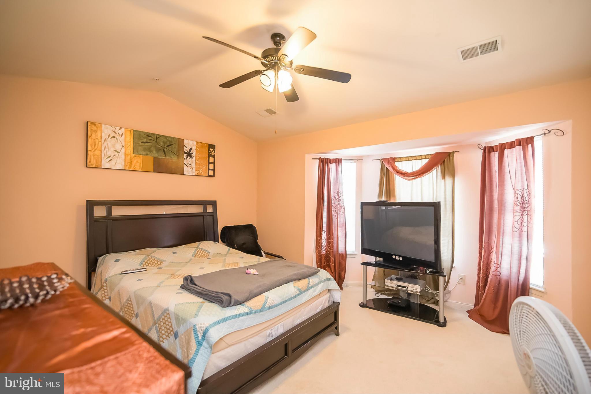631 Hunting Fields Road Baltimore, MD 21220 - Photo 16 of 29 a bedroom with a bed and a flat screen tv