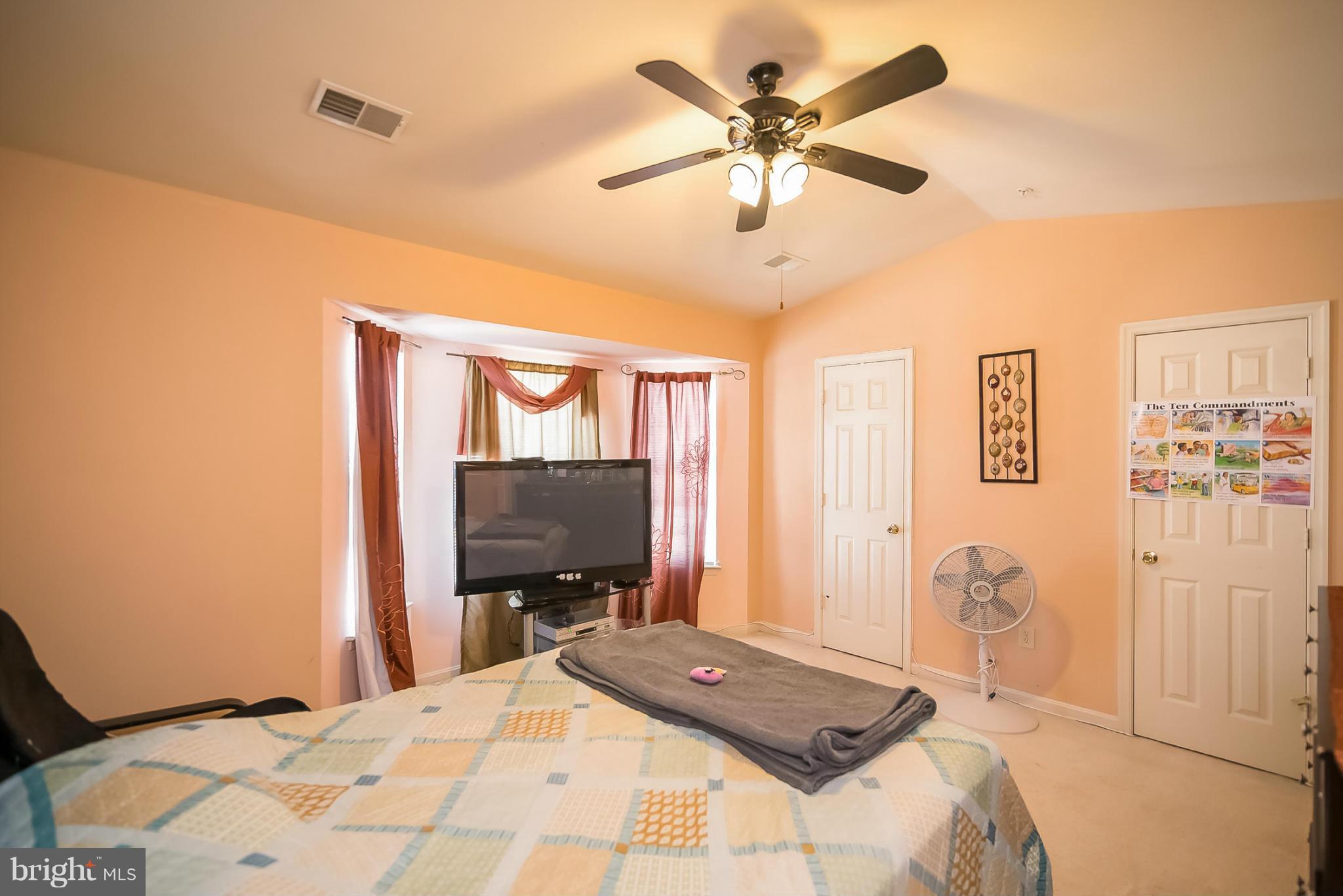 631 Hunting Fields Road Baltimore, MD 21220 - Photo 18 of 29 a bedroom with a bed and a flat screen tv
