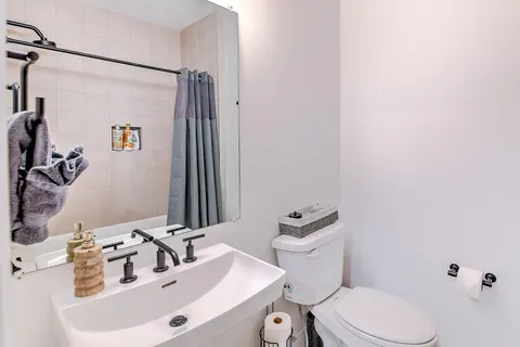 a bedroom with bed and wooden floor