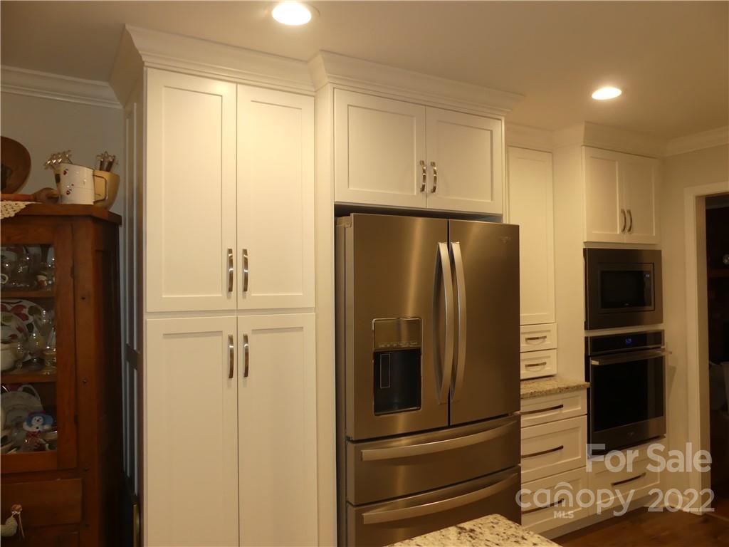 1319 Mooresboro Road Shelby, NC 28150 - Photo 13 of 27 a metallic refrigerator freezer sitting in a kitchen