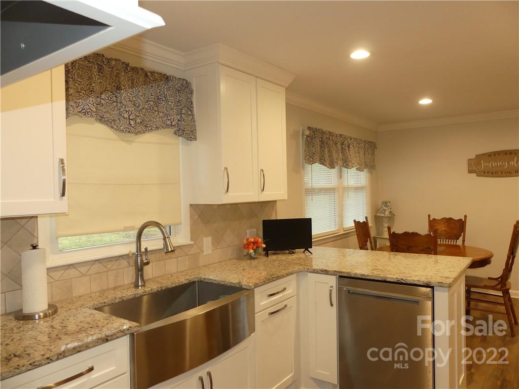 1319 Mooresboro Road Shelby, NC 28150 - Photo 14 of 27 a kitchen with stainless steel appliances granite countertop a sink stove and cabinets