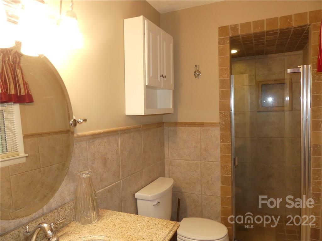 1319 Mooresboro Road Shelby, NC 28150 - Photo 19 of 27 a bathroom with a toilet and a shower
