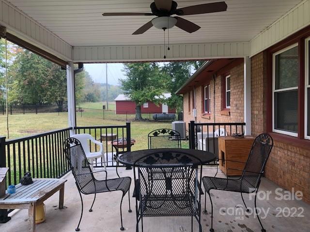 1319 Mooresboro Road Shelby, NC 28150 - Photo 23 of 27 a patio with wooden floor a yard a table and chairs