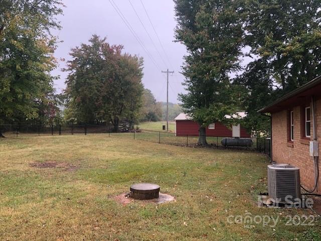 1319 Mooresboro Road Shelby, NC 28150 - Photo 27 of 27 a backyard of a house with table and chairs