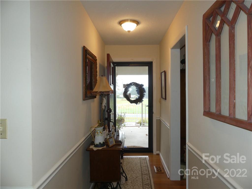 1319 Mooresboro Road Shelby, NC 28150 - Photo 5 of 27 a view of a hallway with wooden floor and stairs