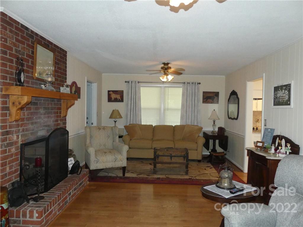 1319 Mooresboro Road Shelby, NC 28150 - Photo 6 of 27 a living room with furniture and a fireplace