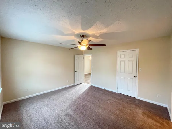 a view of a livingroom with a chandelier fan