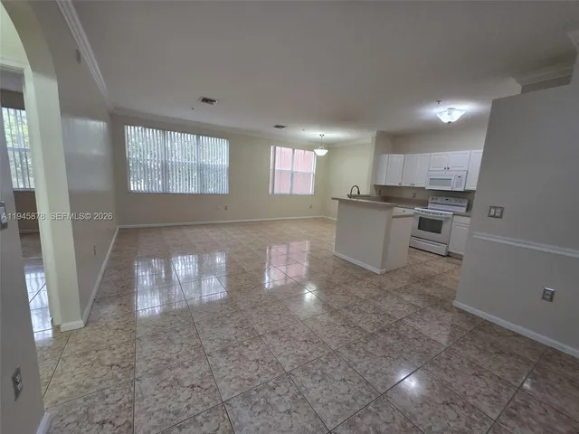a kitchen with a sink microwave and cabinets