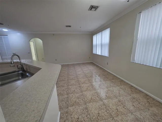 a room with a sink and mirror