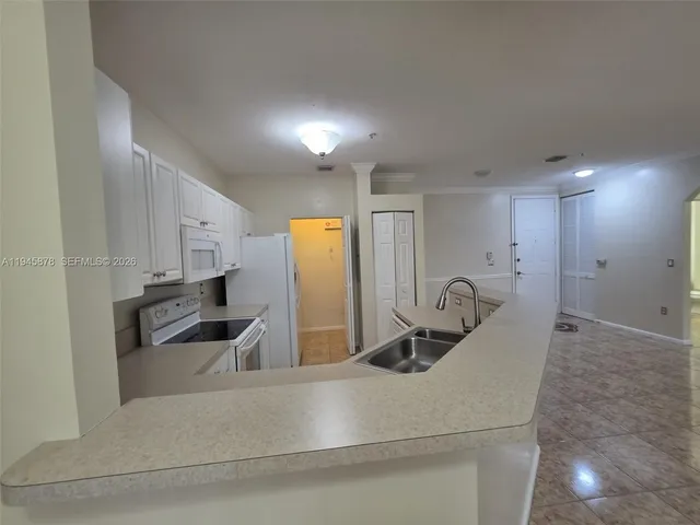 a kitchen with refrigerator and window