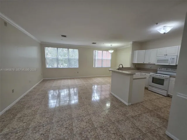 a kitchen with stainless steel appliances granite countertop a stove sink and cabinets