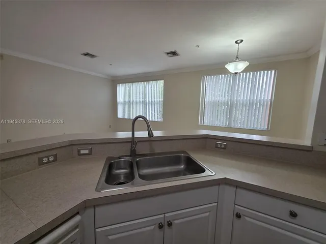 a kitchen with a sink and a window