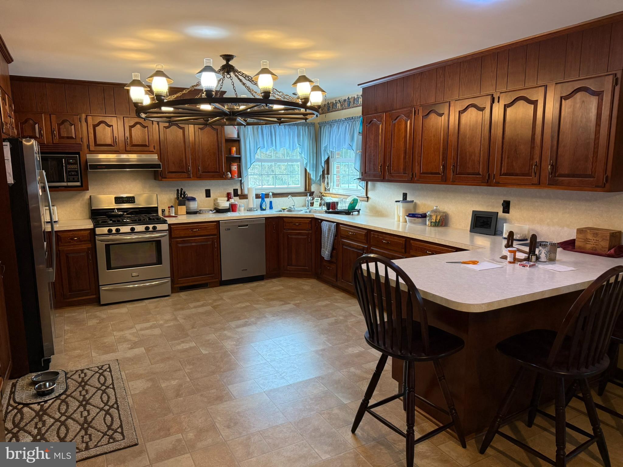 435 Westley Road Mohnton, PA 19540 - Photo 14 of 43 a kitchen with stainless steel appliances granite countertop a table chairs sink and stove
