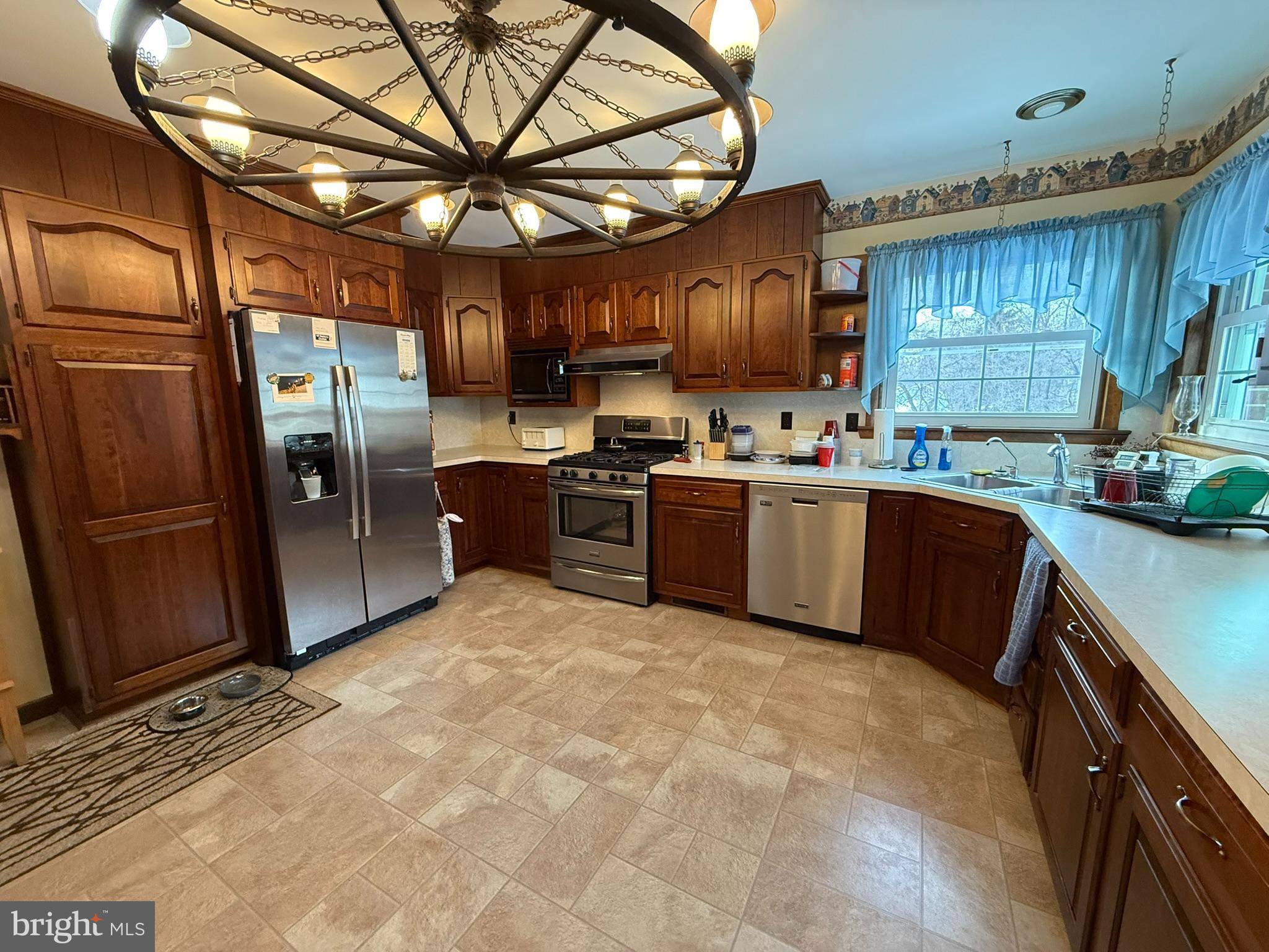 435 Westley Road Mohnton, PA 19540 - Photo 17 of 43 a kitchen with stainless steel appliances granite countertop a sink a stove and a refrigerator