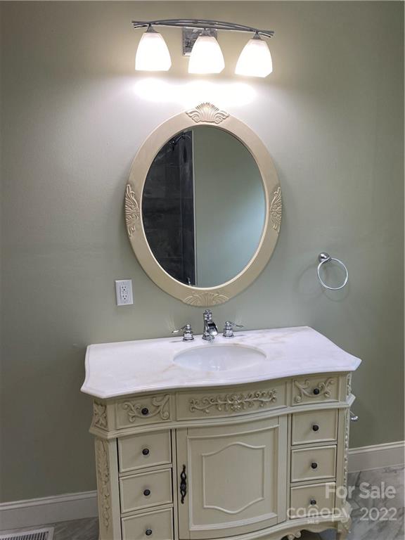 706 Kings Road Shelby, NC 28150 - Photo 12 of 25 a bathroom with a sink and a mirror