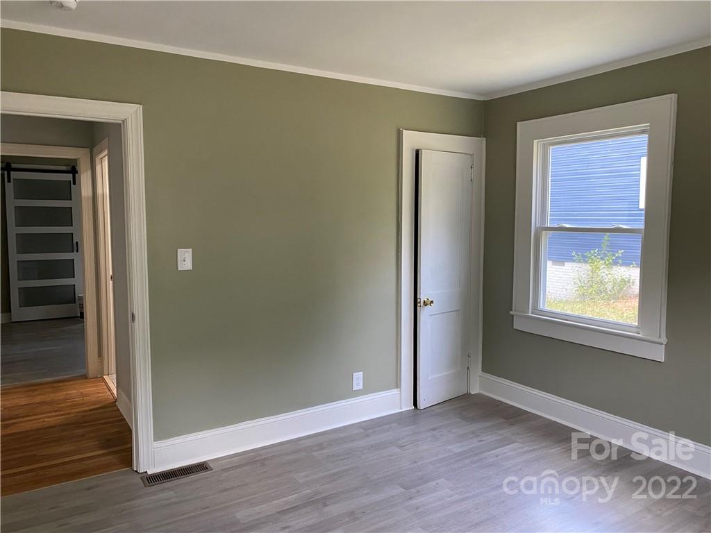 706 Kings Road Shelby, NC 28150 - Photo 16 of 25 an empty room with wooden floor closet and windows
