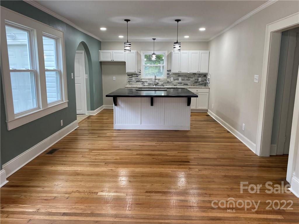 706 Kings Road Shelby, NC 28150 - Photo 3 of 25 a large kitchen with kitchen island a stove a refrigerator a sink and a dishwasher with wooden floor