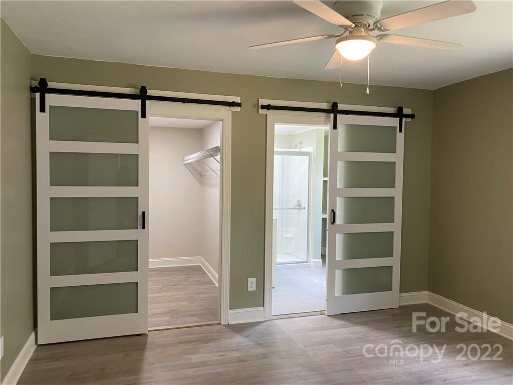 706 Kings Road Shelby, NC 28150 - Photo 7 of 25 a view of an empty room with a window and wooden floor