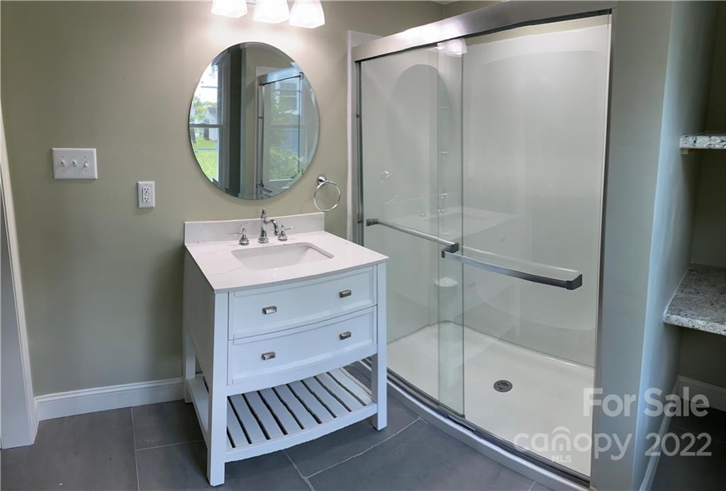 706 Kings Road Shelby, NC 28150 - Photo 10 of 25 a bathroom with a sink a mirror and a shower