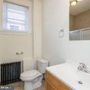 a bathroom with a sink toilet and window