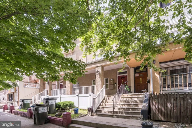 front view of a house with a tree