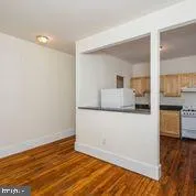 a view of a kitchen with wooden floor