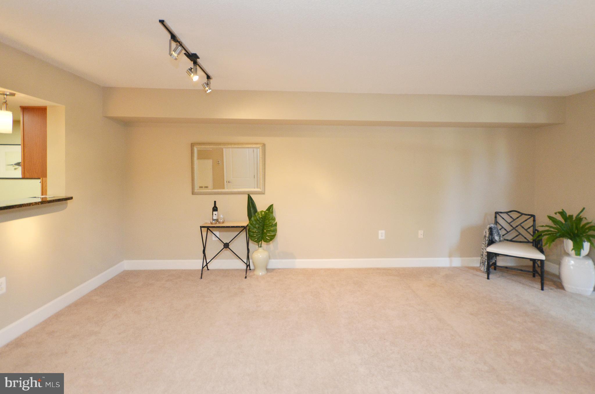 11800 Sunset Hills Road, Unit 210 Reston, VA 20190 - Photo 11 of 30 a living room with furniture and a window