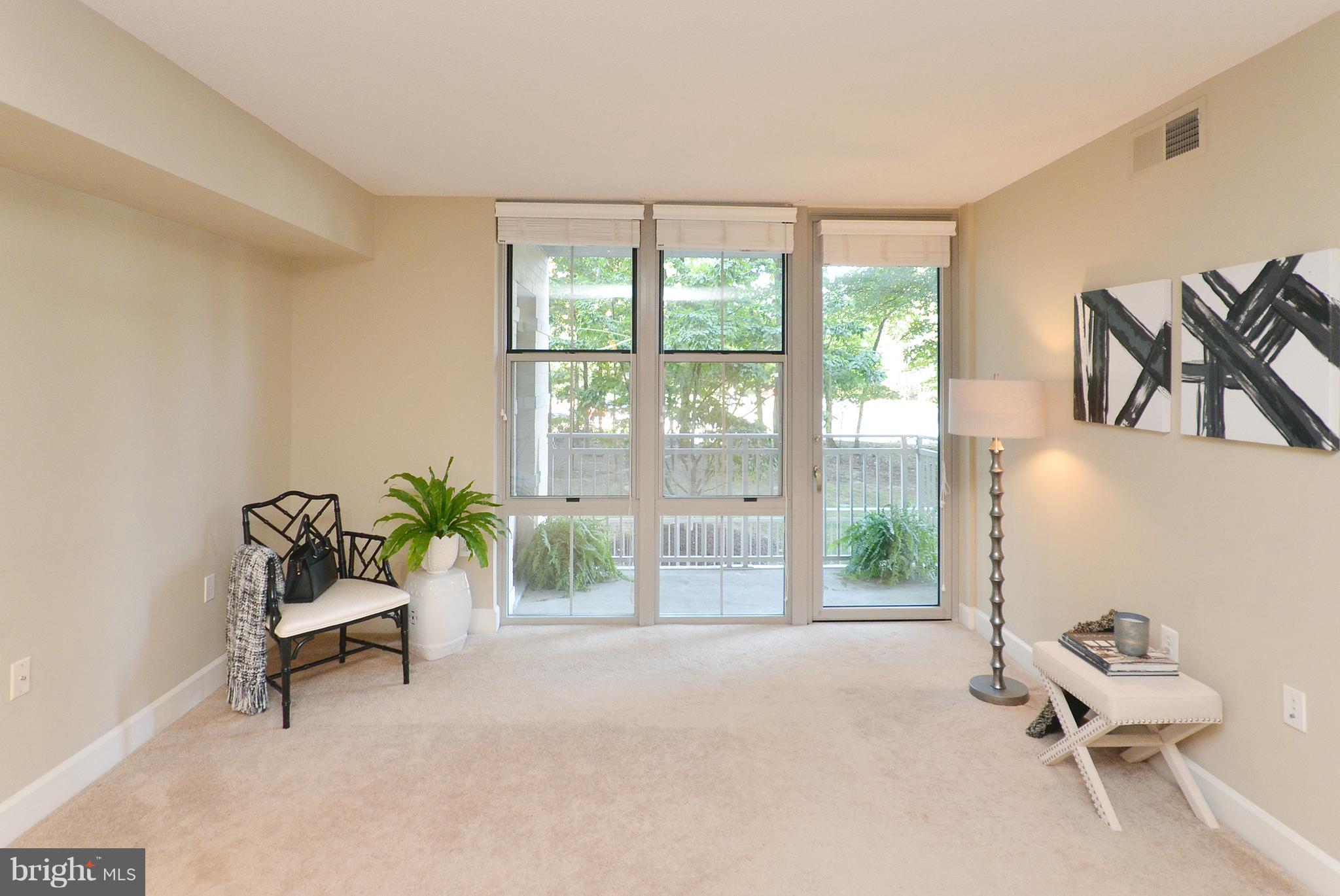 11800 Sunset Hills Road, Unit 210 Reston, VA 20190 - Photo 12 of 30 a living room with furniture and a window