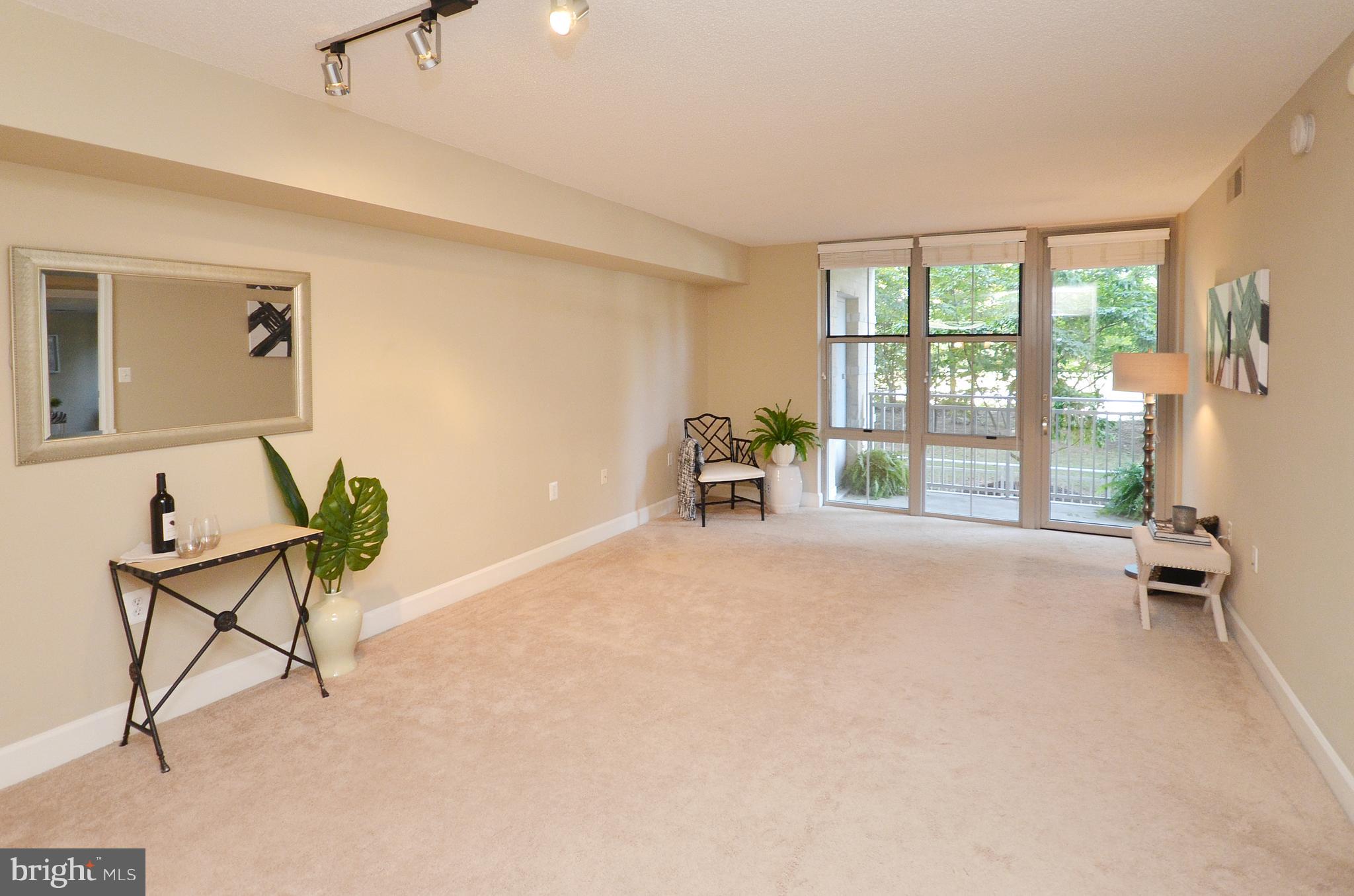11800 Sunset Hills Road, Unit 210 Reston, VA 20190 - Photo 13 of 30 a furnished livingroom with a large window and outside view