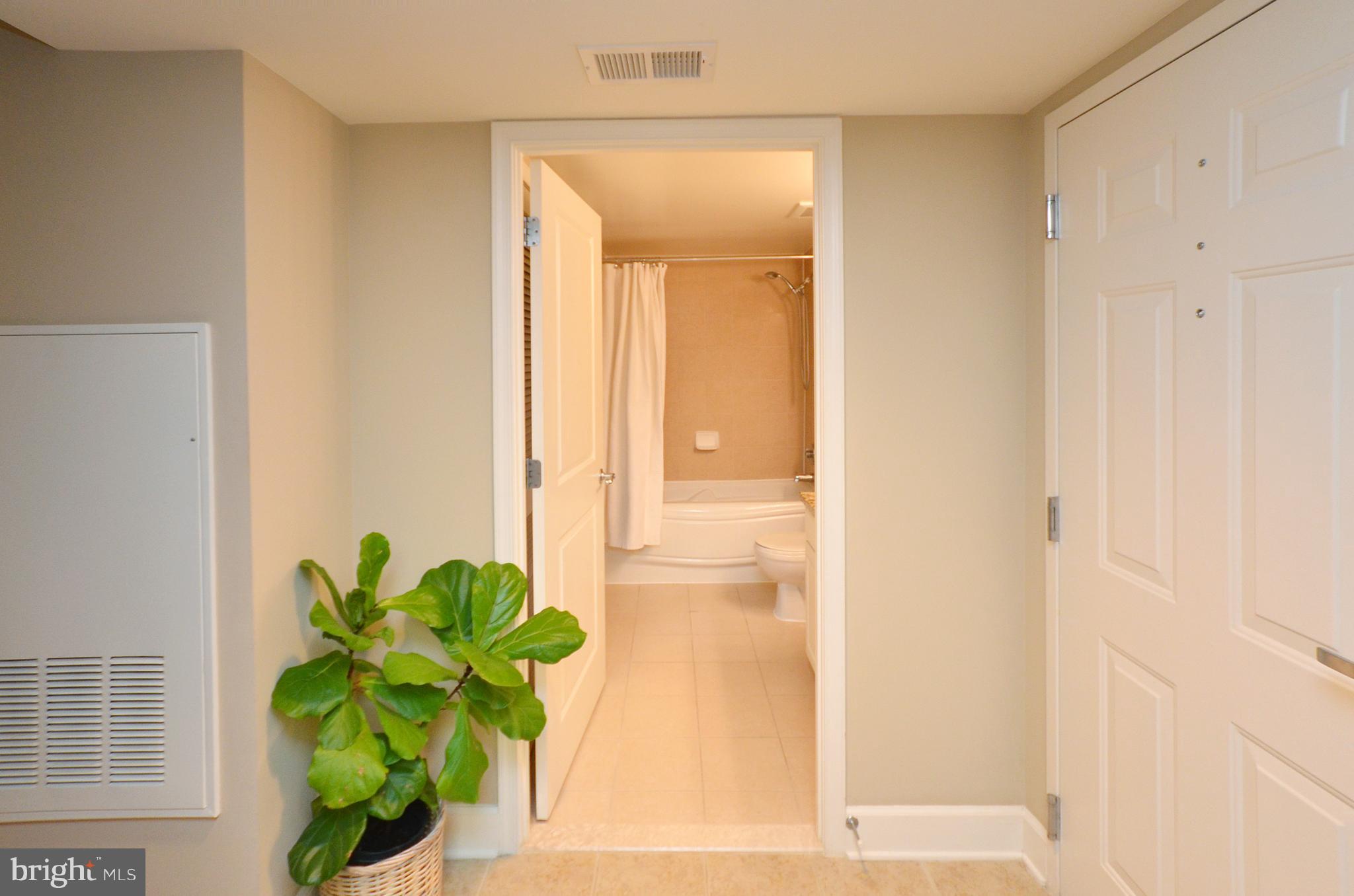 11800 Sunset Hills Road, Unit 210 Reston, VA 20190 - Photo 16 of 30 a view of a hallway with wooden floor and a glass door