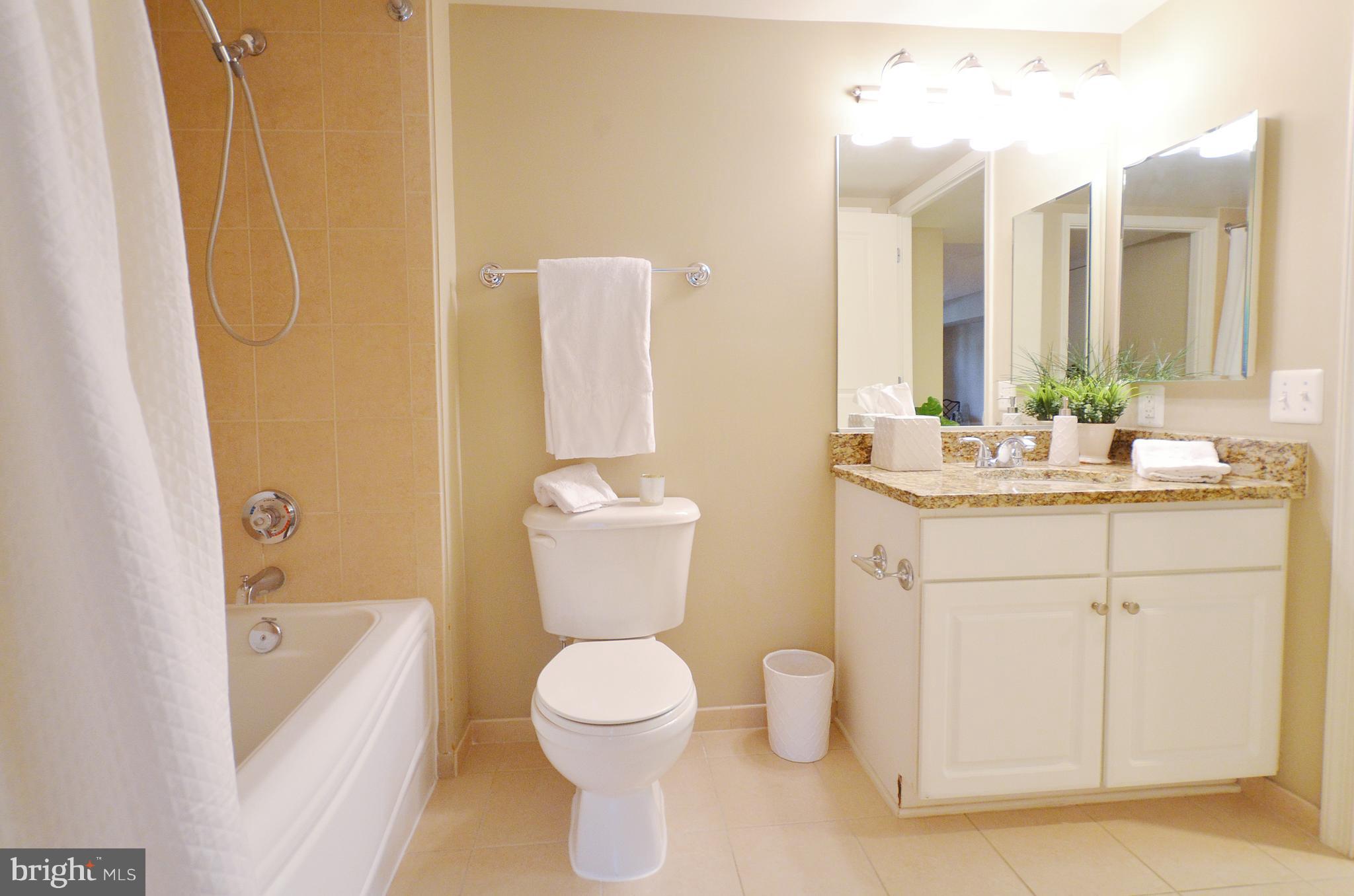 11800 Sunset Hills Road, Unit 210 Reston, VA 20190 - Photo 18 of 30 a bathroom with a sink a toilet and shower