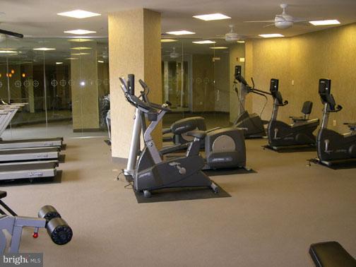 11800 Sunset Hills Road, Unit 210 Reston, VA 20190 - Photo 25 of 30 a room with gym equipment and a mirror