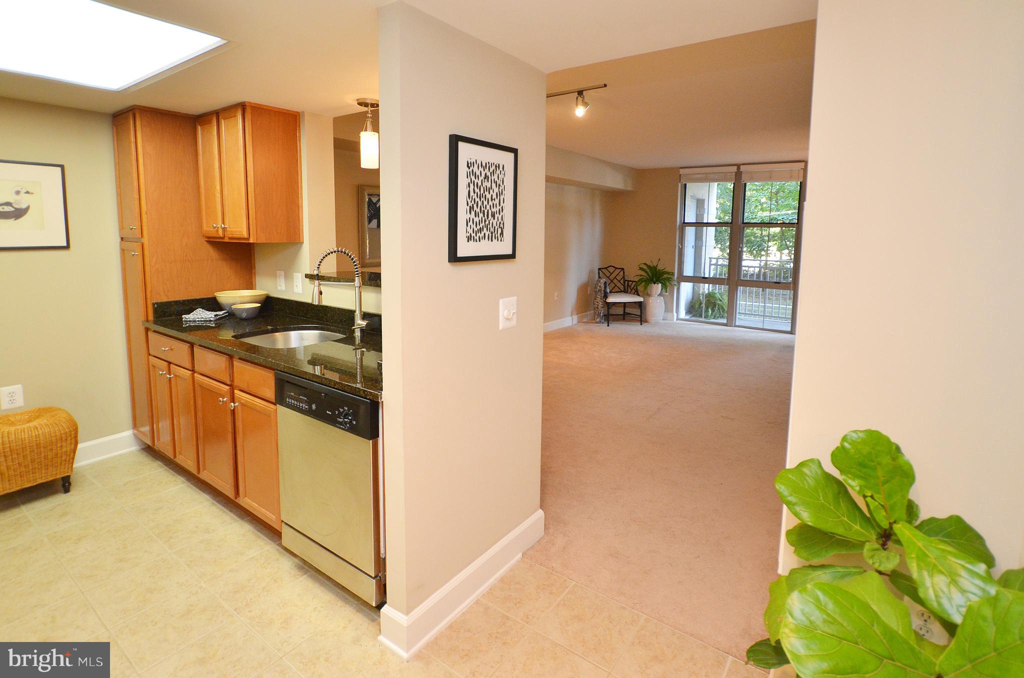 11800 Sunset Hills Road, Unit 210 Reston, VA 20190 - Photo 4 of 30 a kitchen with stainless steel appliances granite countertop a stove a sink and a refrigerator