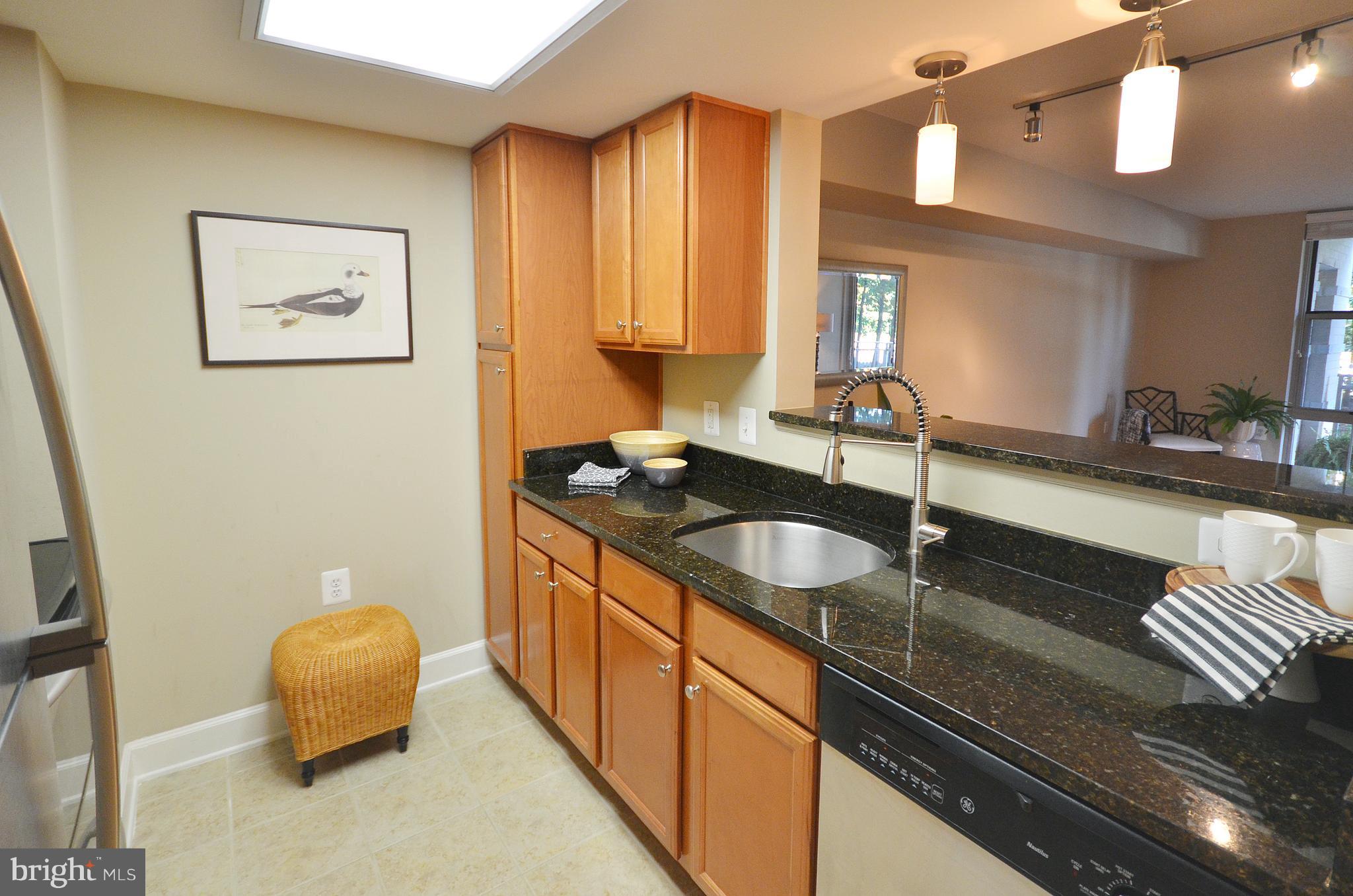 11800 Sunset Hills Road, Unit 210 Reston, VA 20190 - Photo 6 of 30 a bathroom with a granite countertop sink and a mirror