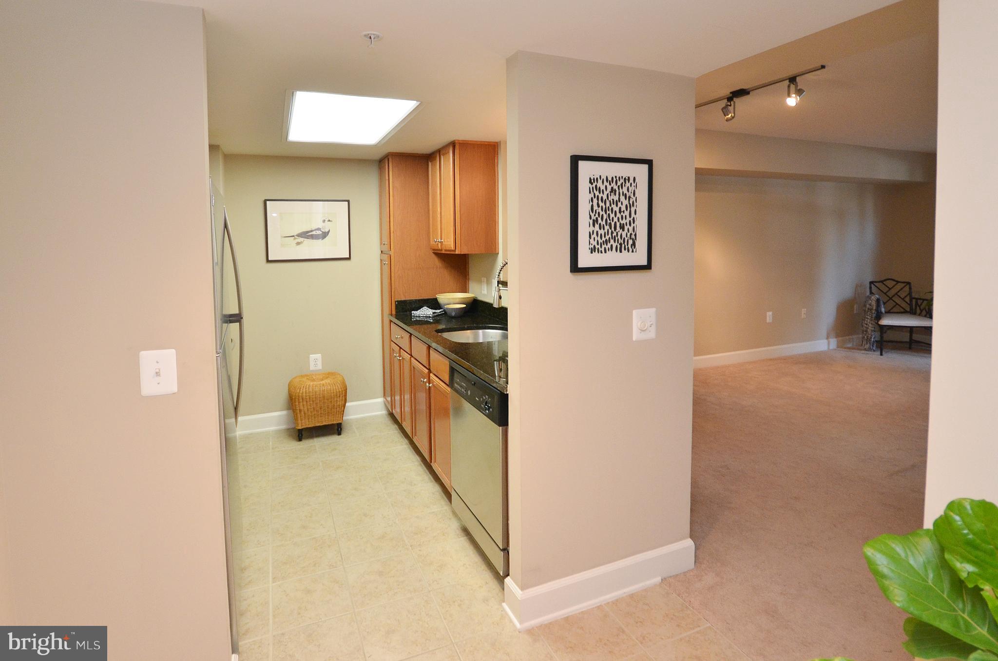 11800 Sunset Hills Road, Unit 210 Reston, VA 20190 - Photo 10 of 30 a kitchen with stainless steel appliances a refrigerator and a stove