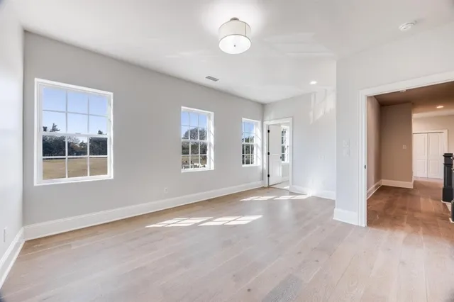 an empty room with windows and entrance