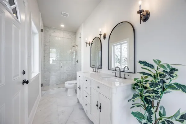 a spacious bathroom with a double vanity sink and a mirror