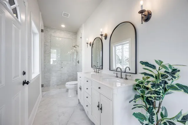 a spacious bathroom with a double vanity sink and a mirror