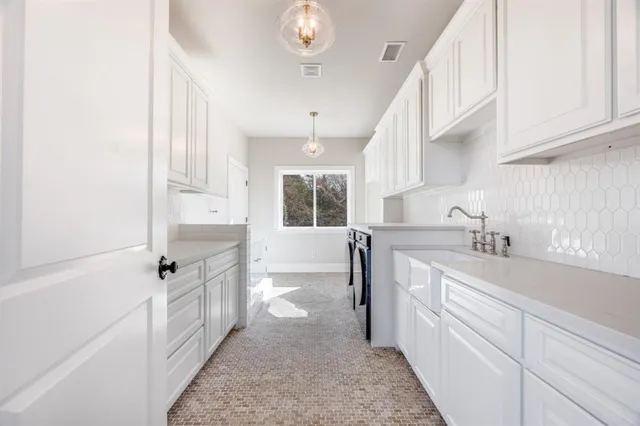 a kitchen with granite countertop a sink and cabinets