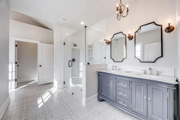 a bathroom with a double vanity sink mirror double and shower