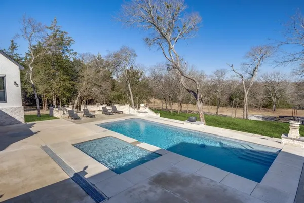 a view of a house with backyard and a garage