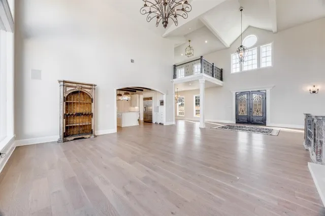 a view of a livingroom with wooden floor and a chandelier