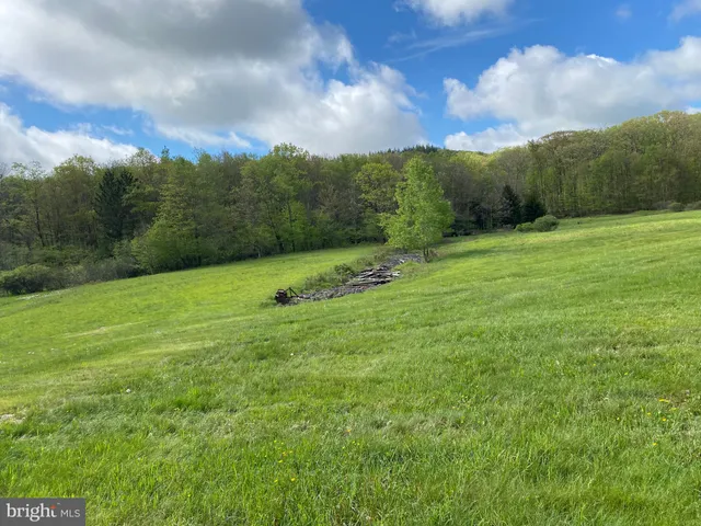 an aerial view of a house with outdoor space