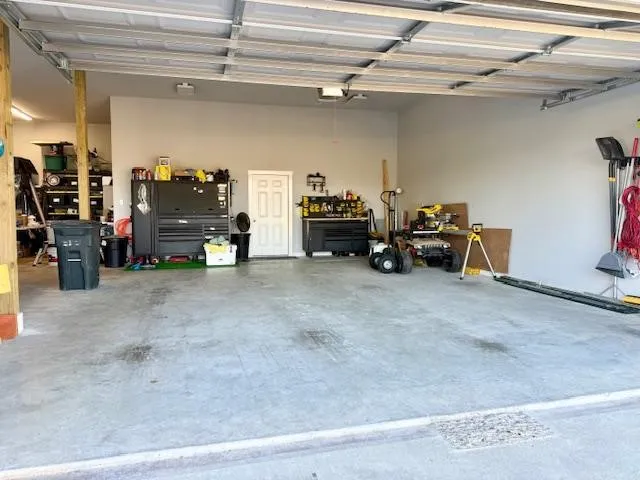 a backyard of a house with garden and barbeque oven